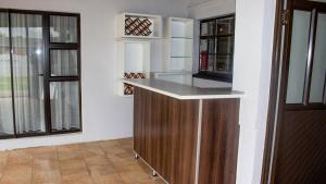 a kitchen with a counter and two windows at Phela Guesthouse in Edenvale