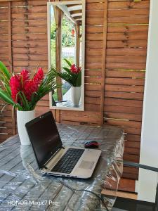 a laptop computer sitting on top of a table at Enjoy Studio in Pointe-Noire
