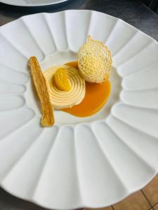 a white paper plate with food on it at Hôtel Le Castanea Entre Aurillac et Marcolès Auvergne in Roannes-Saint-Mary