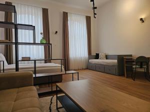 a living room with two beds and a table at ELEVEN APARTMENT - Very Center - Free Parking in Osijek