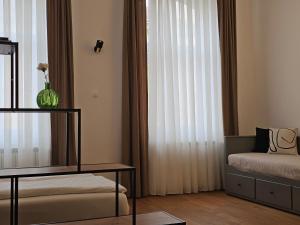 a bedroom with a bed and a window with curtains at ELEVEN APARTMENT - Very Center - Free Parking in Osijek