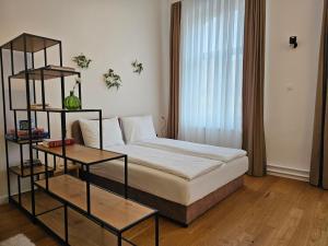 a bedroom with a bed and a book shelf at ELEVEN APARTMENT - Very Center - Free Parking in Osijek +27 photos