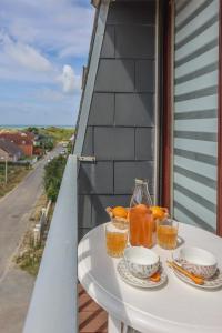 a table with plates of food on a balcony at La Clé des Sternes in Camiers