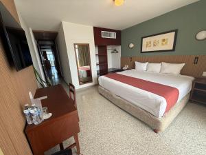a hotel room with a large bed and a desk at Hotel Royalty in Veracruz +65 photos
