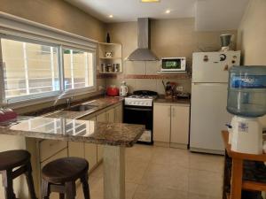 a kitchen with a counter top and a refrigerator at Lihuen in Mar Azul