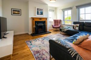 a living room with a couch and a fireplace at Wild Atlantic Hideaway in Doolin
