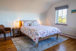 a bedroom with a bed and a window at Wild Atlantic Hideaway in Doolin