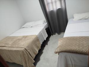 two beds sitting next to each other in a room at DSá Hotel in Cristalândia