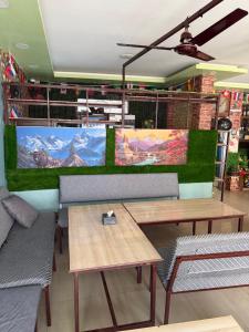 a restaurant with benches and tables in a room at Universal Hotel & Lodge - Gorkha in Gorkhā
