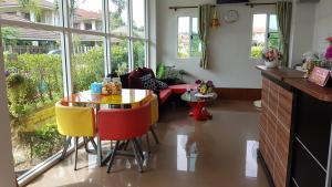 a kitchen with a table and chairs in a room at Na Dream Place in Surat Thani