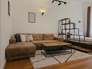 a living room with a couch and a coffee table at ELEVEN APARTMENT - Very Center - Free Parking in Osijek
