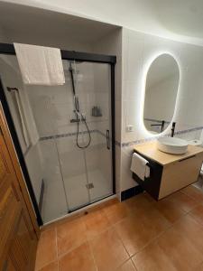 a bathroom with a shower and a sink at Las 6 llaves in Baeza +28 photos