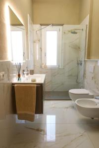 a bathroom with a sink and a toilet and a shower at Holiday Vibes in Pisa