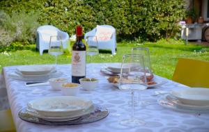 a table with glasses of wine and plates of food at Holiday Vibes in Pisa