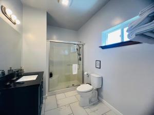 a bathroom with a shower and a toilet and a sink at Vynmir BeachPark Villa in Fort Bragg +37 photos
