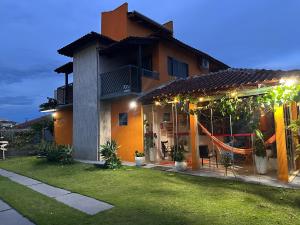 a house with a hammock in the front yard at Pousada Luar in Chapada dos Guimarães