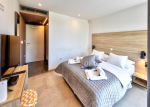 a bedroom with a large bed with towels on it at Villa Radman in Korčula +13 photos