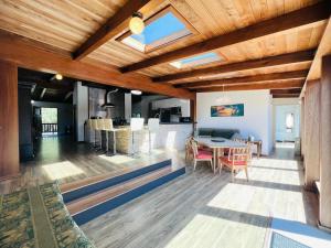 a dining room and living room with wood ceilings at Vynmir BeachPark Villa in Fort Bragg