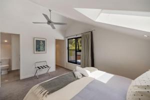 a bedroom with a large bed and a window at Chartres Retreat in Arrowtown