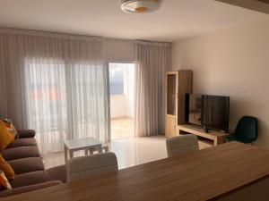 a living room with a television and a table and chairs at Valdés in Callao Salvaje