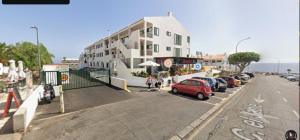 a parking lot with cars parked next to a building at Valdés in Callao Salvaje