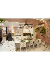 a kitchen with a table and chairs in it at Raskunj Farm in Noida
