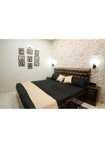 a bedroom with a bed and a brick wall at Raskunj Farm in Noida +24 photos