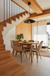 a dining room with a table and chairs and a staircase at NOOK Cabins - Mountain View in Zakopane