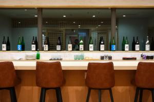 a bar with a bunch of bottles of wine at Matsuya hotel in Myoko