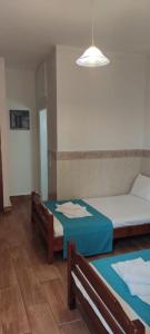 a room with two beds and a light at Bambola Apartments in Nea Moudania