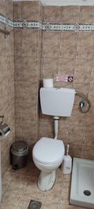 a small bathroom with a toilet and a sink at Bambola Apartments in Nea Moudania