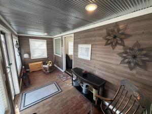 a room with a wooden wall with a table and chairs at Albert Lea revival in Albert Lea
