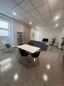 a room with a table and chairs and a couch at Casa São Marcos II in Peniche