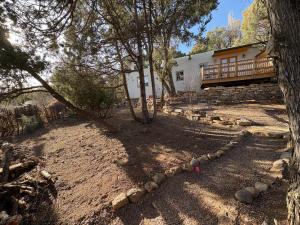 a backyard with a house and a tree at High Moon 4 Ten Thousand Waves Way in Santa Fe