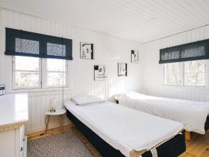 two beds in a room with white walls and windows at 6 person holiday home in Grevinge-By Traum in Grevinge