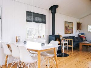 a dining room with a table and white chairs at 6 person holiday home in Grevinge-By Traum in Grevinge