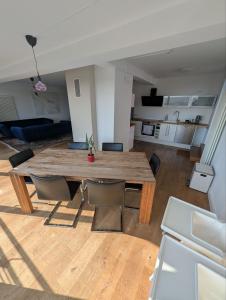 a living room with a wooden table and chairs at Large city apartment with beautiful views in Marburg an der Lahn +27 photos