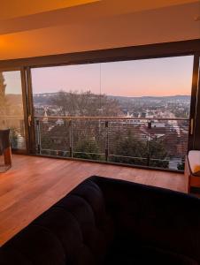 a living room with a large window with a view at Large city apartment with beautiful views in Marburg an der Lahn
