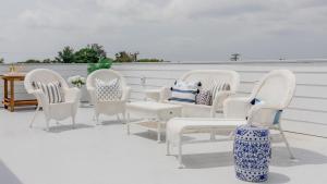 a group of chairs and a table on a patio at The Ocean Loft At Kings in Cape May