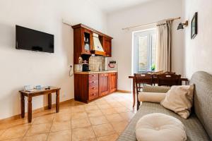 a living room with a couch and a table at Vicolo 35 Apartments in Trapani