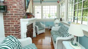 a living room with two chairs and a fireplace at Windsor Escape in Cape May