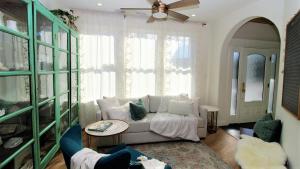 a living room with a couch and a ceiling fan at 12 Pearls in Cape May Point