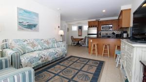 a living room with a couch and a kitchen at Broadway Beach Unit 7 in Cape May