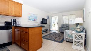 a kitchen with a counter and a living room at Broadway Beach Unit 7 in Cape May