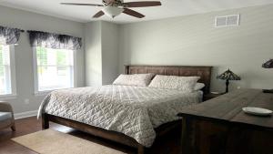 a bedroom with a bed and a ceiling fan at Bay Breeze in Town Bank