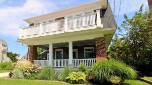 a house with a balcony on top of it at The Cape May Diamond in Cape May