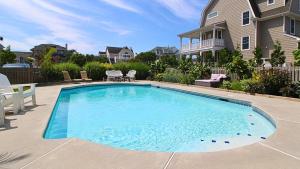 a swimming pool in front of a house at The Cape May Diamond in Cape May