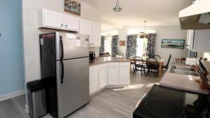 a kitchen with a refrigerator and a dining room at 149 Emerald Avenue in West Cape May