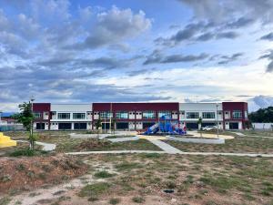 a school building with a playground in front of it at Zahran Homestay in Papar