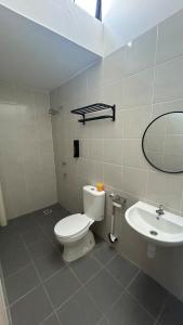 a bathroom with a toilet and a sink at Zahran Homestay in Papar +17 photos